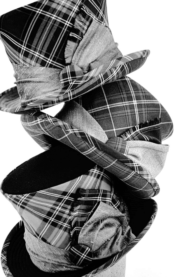 A stack of three tartan Top Hats.